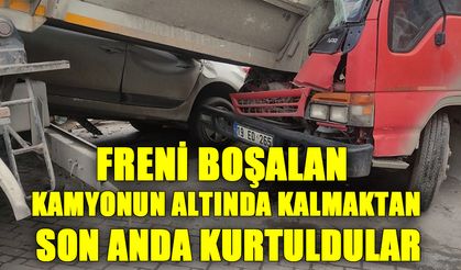 Freni boşalan kamyonun altında kalmaktan son anda kurtuldular